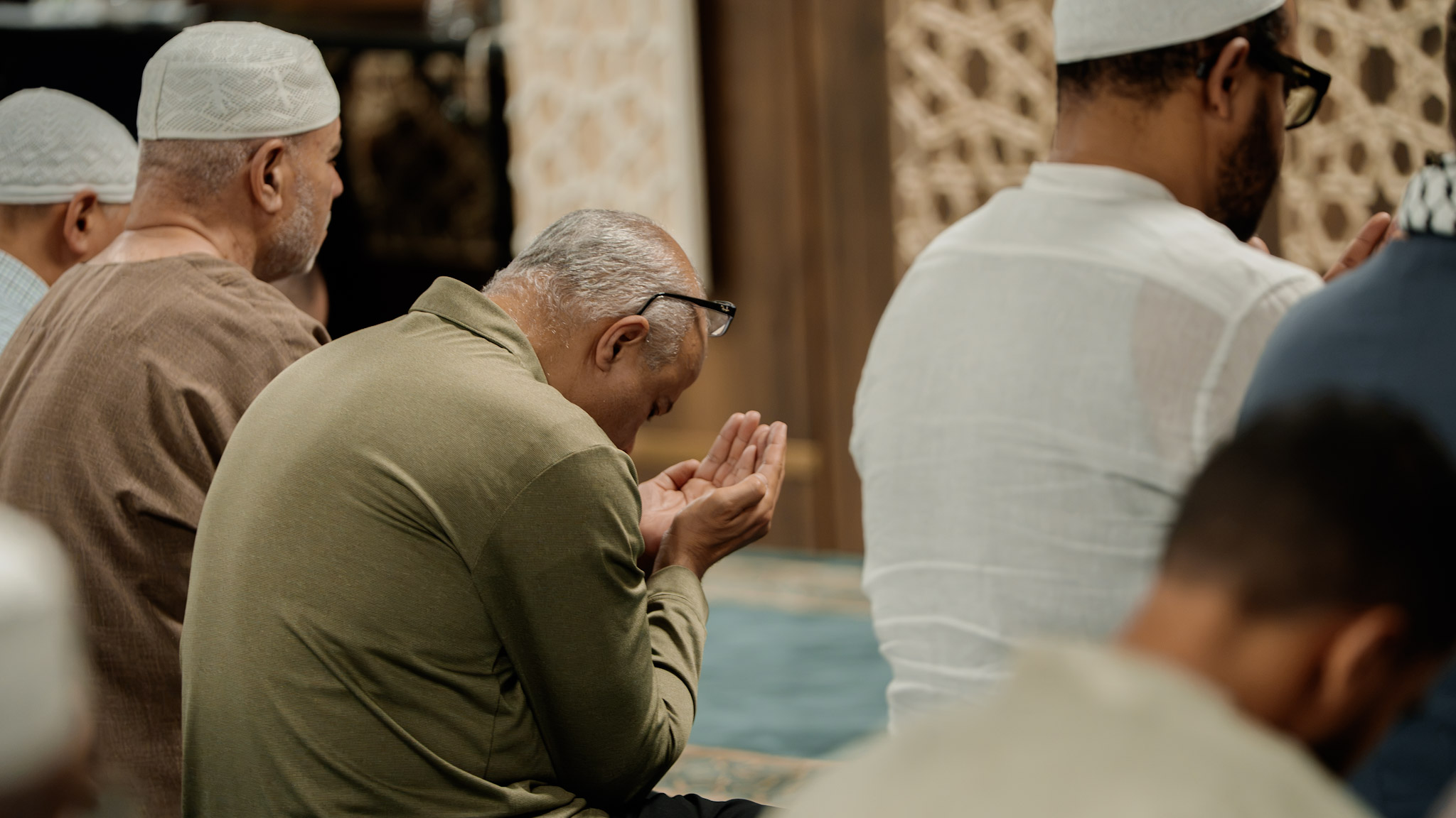 Hands raised in du'a among the congregation at Nafis Masjid, Boston