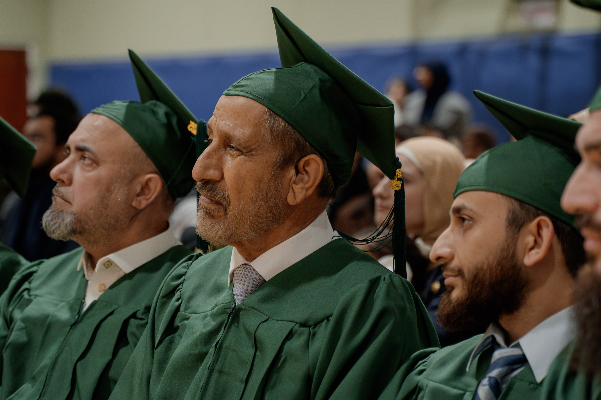Graduates in green regalia at the 2025 certificate program graduation
