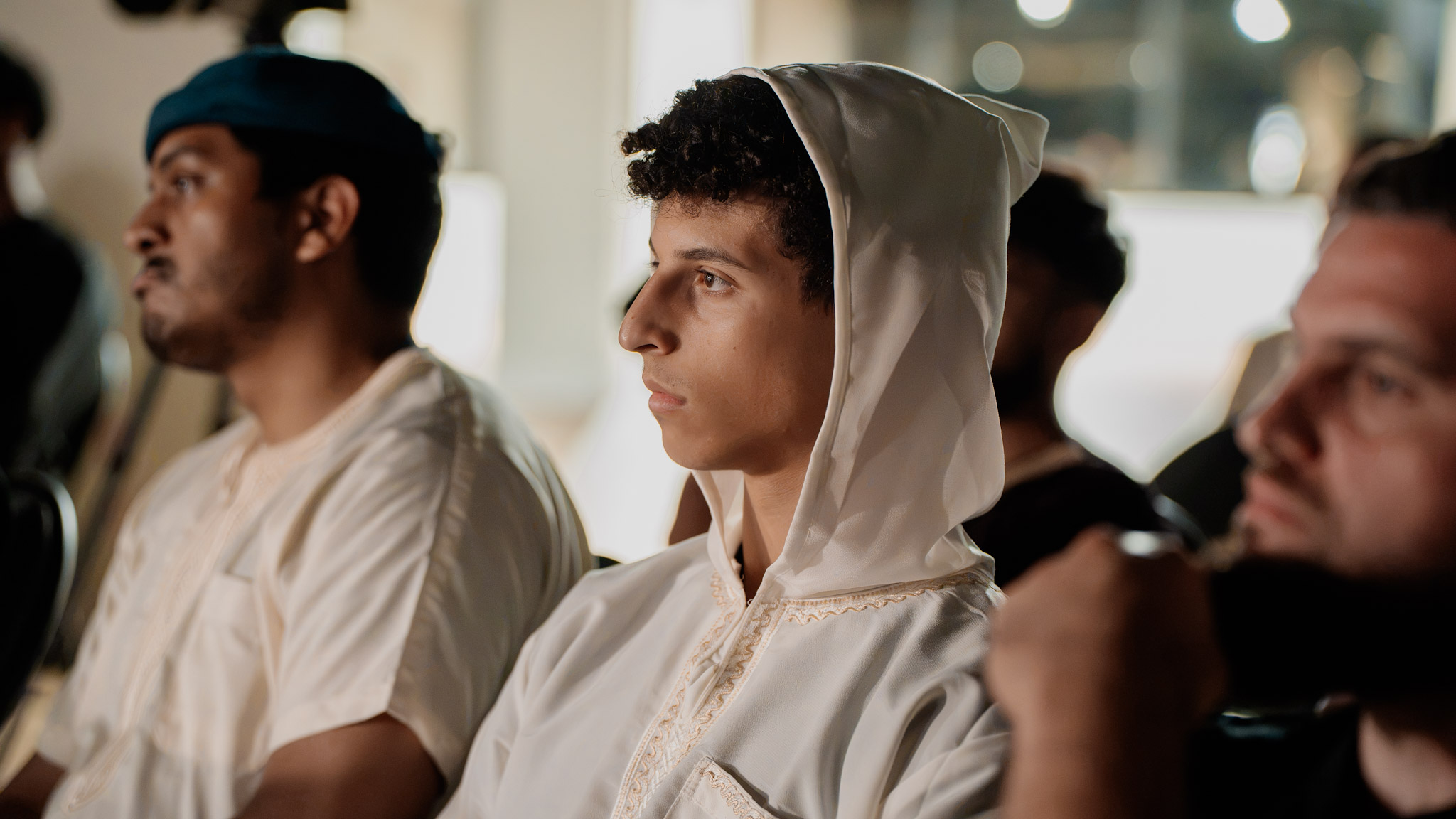 Hooded audience member in profile at the Unscripted taping